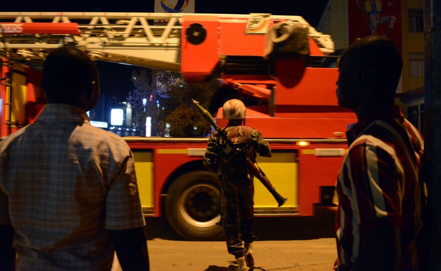A soldier stands near a hotel that was attacked by militants on Friday in Burkina Faso's capital, Ouagadougou.