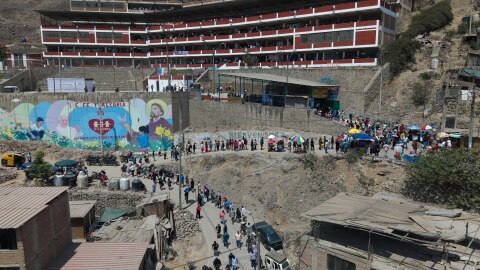 Voters line up outside a polling station during general elections in Lima, Peru, Sunday, April 12, 2026.