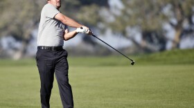 Nicholas Thompson watches his second shot to the green on the par five 14th hole on the north course at Torrey Pines during the first round of the Farmers Insurance Open golf tournament, Feb. 5, 2015.