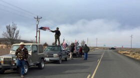 People wave American flags near the Malheur National Wildlife Refuge, near Burns, Oregon, Feb. 11, 2016.