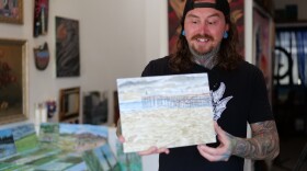 Skateboarder and artist Hunter Knolmayer holds up one of his paintings on Feb. 15, 2026.