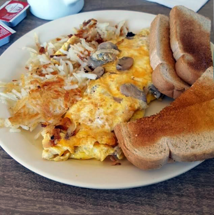 A classic breakfast plate at Lucky's Golden Phenix in North Park, featuring hash browns, an omelet and toast.