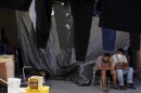Men wait at a shelter for migrants Thursday, April 21, 2022, in Tijuana, Mexico. A critical Trump-era policy that forces asylum-seekers to wait in Mexico for hearings in U.S. immigration court will be argued Tuesday before the U.S. Supreme Court.