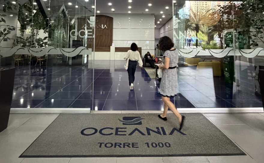Workers enter the Oceania Business Plaza in Panama City. Polymarket claims its headquarters is on the 21st floor of the building. So do more than a dozen other crypto companies. But the address leads to a law firm.
