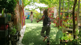 Kids run in the backyard of Liberty Winn's childcare center in Carlsbad, May 18, 2022.