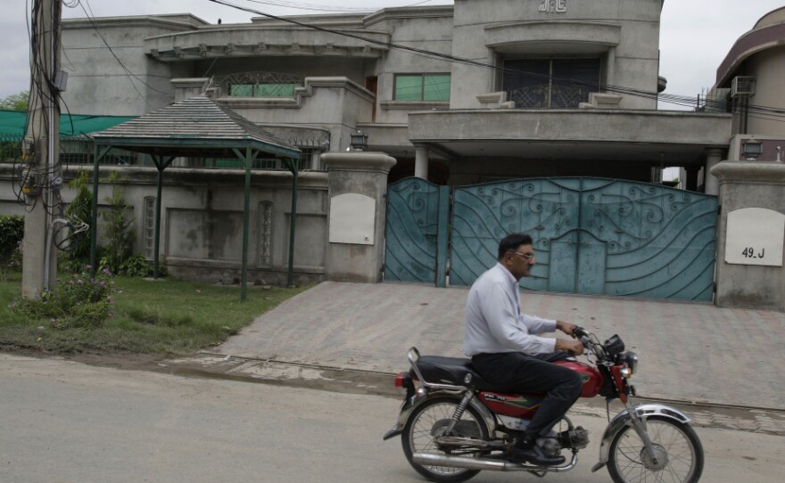 A man rides past the house of kidnapped American aid expert Warren Weinstein in Lahore, Pakistan. Weinstein was kidnapped more than two months ago; so far no demands have been made for his return.