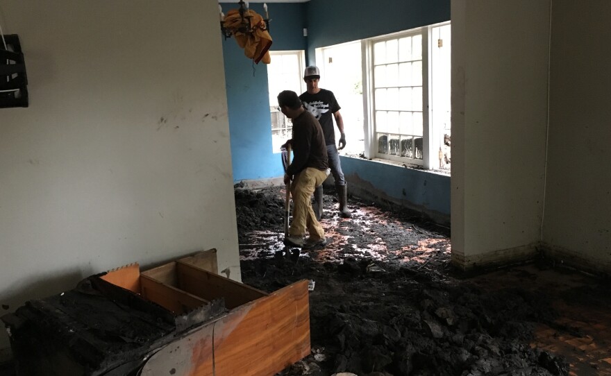 Jed Hirsh of Summerland and Josiah Hamilton of Montecito dig out the dining room of Peri Thompson's Montecito, Calif. house.