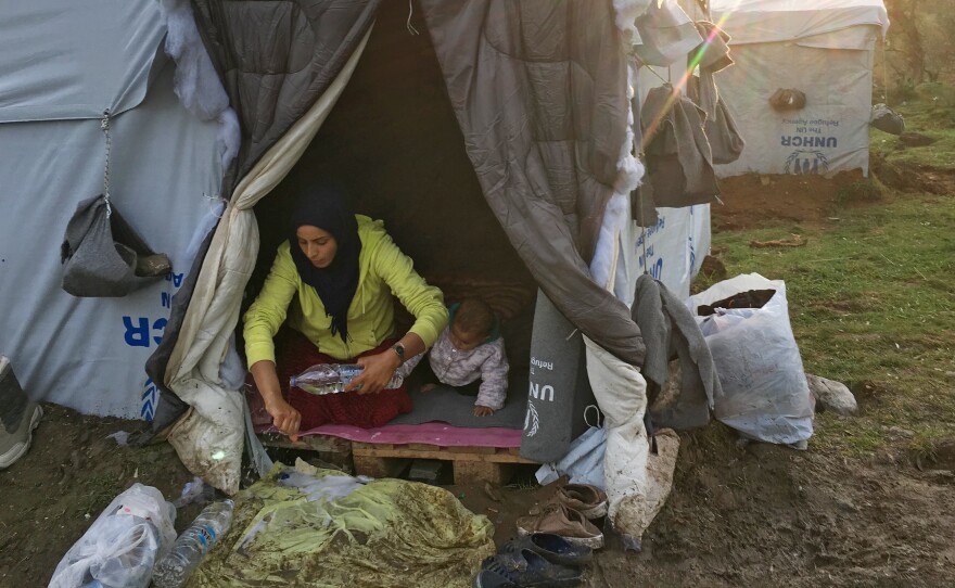 Rasha al-Ahmad, 25, washes her hands with donated bottled water inside a tent her family put up next to the Moria refugee camp. Her 1-year-old daughter, Tamar, is next to her. "The biggest challenge is keeping myself and my children clean," she says.