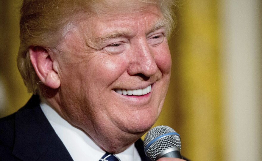 President Trump speaks at a reception for senators and their spouses in the East Room of the White House on Tuesday.