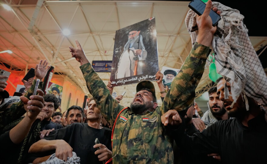 An Iraqi Shiite soldier chants on the eve of funeral ceremonies for the late Iranian Supreme Leader Ayatollah Ali Khamenei outside the Imam Ali Shrine in Najaf, Iraq, Tuesday, July 7, 2026.