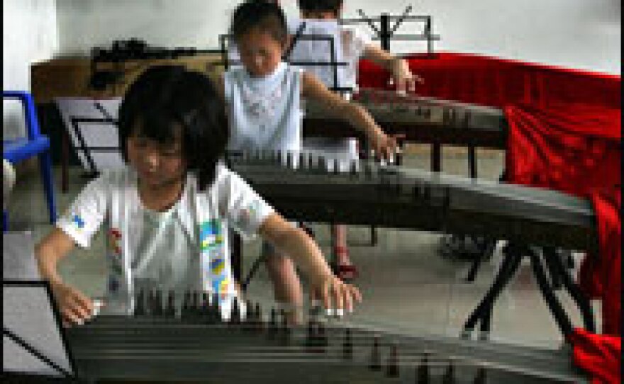 Children play the guzheng, a Chinese horizontal harp, at the Long Yun Gu Zheng Training Academy in Chengdu.