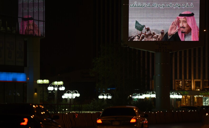 A billboard in Riyadh, the Saudi capital, features an image of soldiers and a portrait of Saudi King Salman.