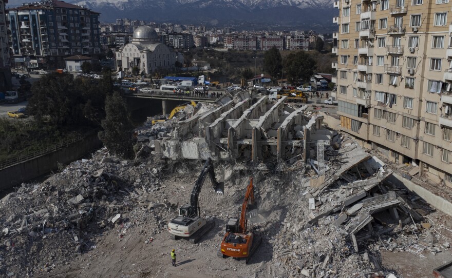 An aerial view shows rescue team searching through a collapsed building in Hatay, Turkey.