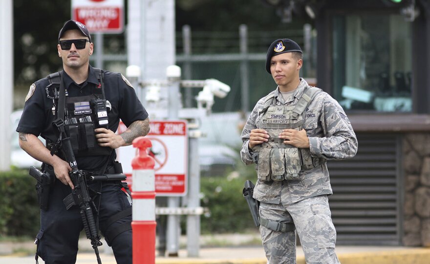 Security guards outside the main gate at Joint Base Pearl Harbor-Hickam, in Hawaii, following a shooting by an active-duty U.S. Navy sailor.
