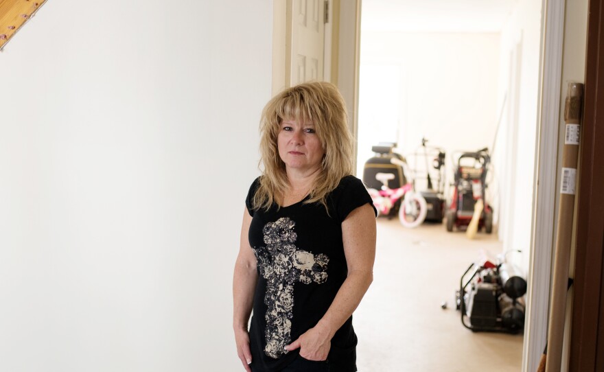 Diane Camerada stands inside her home on Staten Island, N.Y. She has been frustrated with the long bureaucratic process with the Build It Back program.