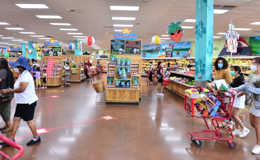 Trader Joe's says it is in the process of discontinuing some of its product branding. Here, shoppers buy groceries at a store last week in Pembroke Pines, Fla.
