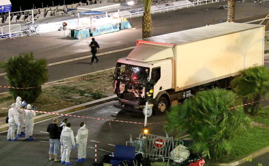 Authorities investigate a truck after it plowed through Bastille Day revelers in the French resort city of Nice, France, on Thursday evening.