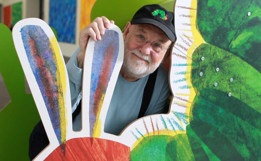 Eric Carle with a cutout of his famously hungry caterpillar at the Eric Carle Museum of Picture Book Art in Amherst, Mass.