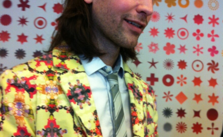 One of the best outfits at the exhibit wasn't actually part of the show: Museumgoer Aaron Peterman designed and made this suit, with its pattern of legendary drag queens on a sunny yellow background.