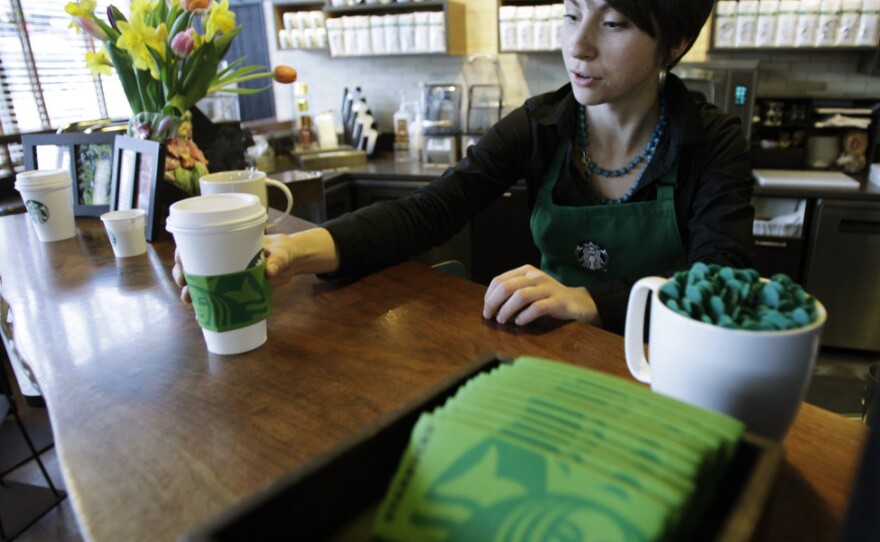 Barista Nicole Adams serves up a drink in March at a Starbucks in downtown Seattle. The company is expanding its coffee options to include a light roast and plans to create a new health and wellness brand.