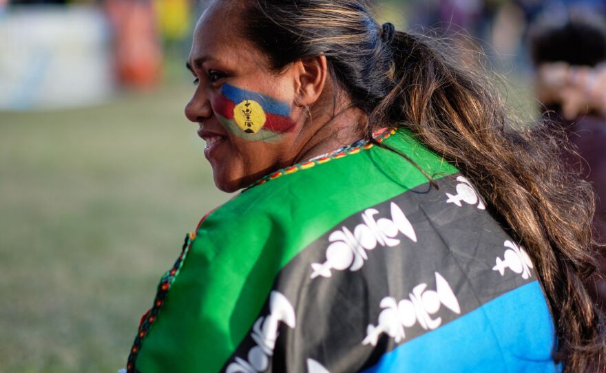 An independence supporter with a flag of the Socialist Kanak National Liberation Front (FLNKS) on October 1, 2020.