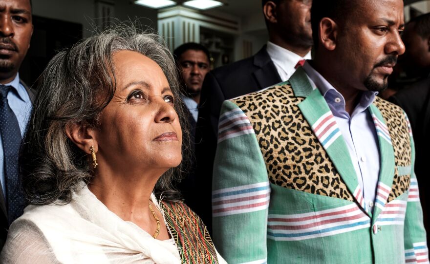 Sahle-Work Zewde walks with Prime Minister Abiy Ahmed after being appointed Ethiopia's first female president at the country's parliament in Addis Ababa on Thursday.