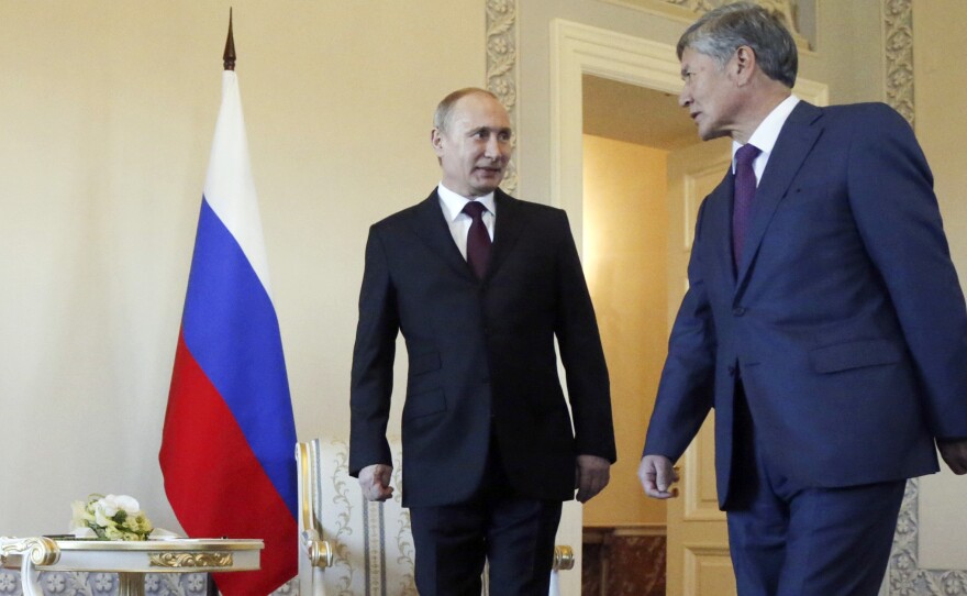 Russian President Vladimir Putin and his Kyrgyz counterpart, Almazbek Atambayev, arrive for a meeting at the Constantine Palace in St. Petersburg Monday.