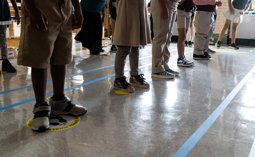 In order to keep them as separated as possible, students in Quesada's third grade class stand on carefully placed stickers on the floor. Because of the space instruments take up, and the need for students to be able to see their teacher, there's often only room for children to stand 3 feet apart, instead of 6.