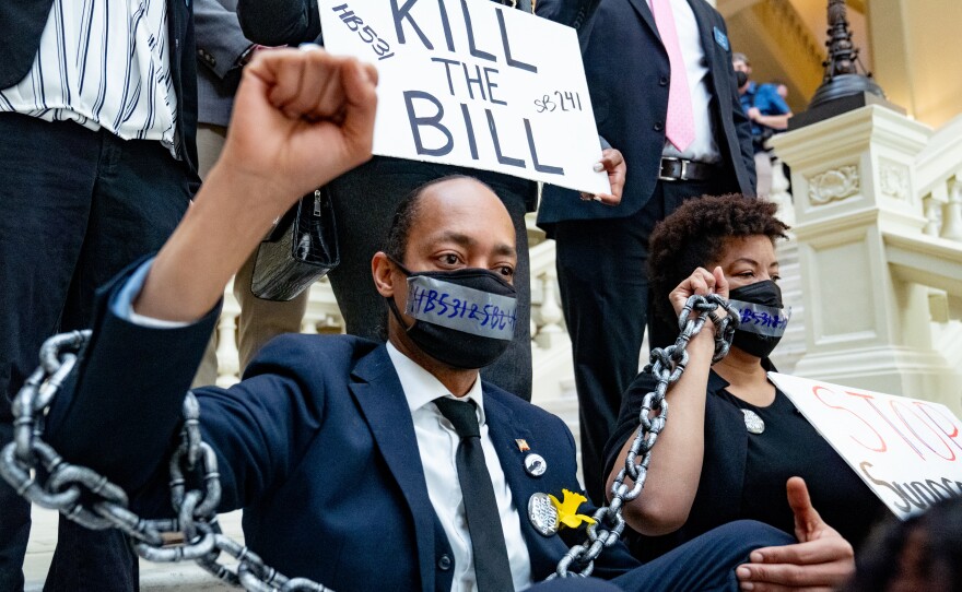 Demonstrators who oppose voting bills wear chains while holding a sit-in inside of the Georgia Capitol building in Atlanta on Monday.