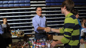 Mitt Romney helps collect and pack donated goods for those affected by Hurricane Sandy, in Kettering, Ohio, on Tuesday.