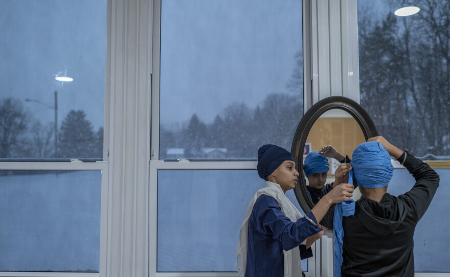 Sukhman Kaur helps Harsaajan Singh with his turban during a turban-tying class at the Gurudwara Dashmesh Darbar in Solon, Ohio. In Sikh culture, tying the turban is an important tradition that represents discipline, respect and a visible expression of faith. Many gurdwaras hold turban-tying workshops for children, helping them learn and take pride in their Sikh identity. These spaces play a vital role in passing down cultural values, especially as younger generations navigate and balance their lives between Sikh and Western identities.
