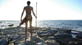 An actor portraying a member of the tiny population of Homo sapiens from whom we all sprang. Geneticists have traced our ancestry to a bare 600 individuals who lived on the shores of Pinnacle Point, South Africa, learning to read the moon to exploit a rich marine resource.