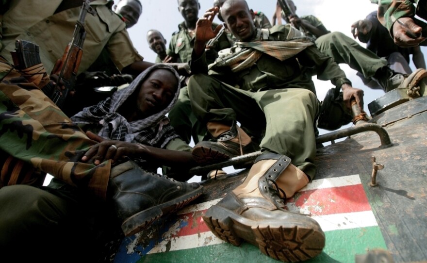 Sudanese soldiers step on the South Sudan flag painted on a seized tank for the Sudanese Peoples Liberation Army in Heglig last month.