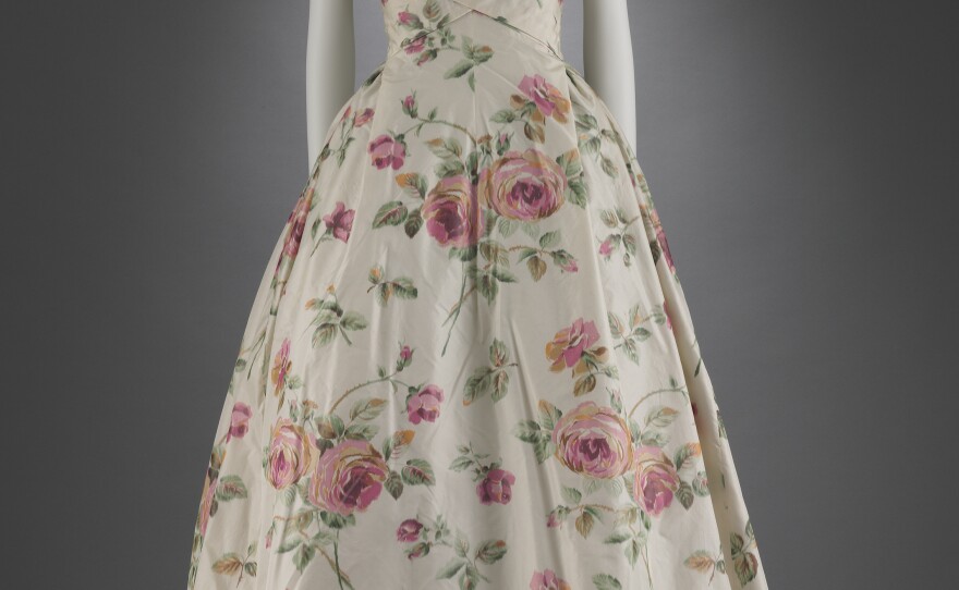 Big, pink flowers bloom on ivory silk in this 1956 dress by Christian Dior.