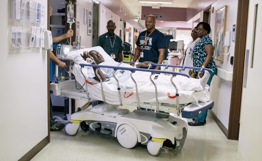 David Eurey is moved via a self-driving gurney that does not need any force by the person driving it at the VA hospital in Loma Linda.