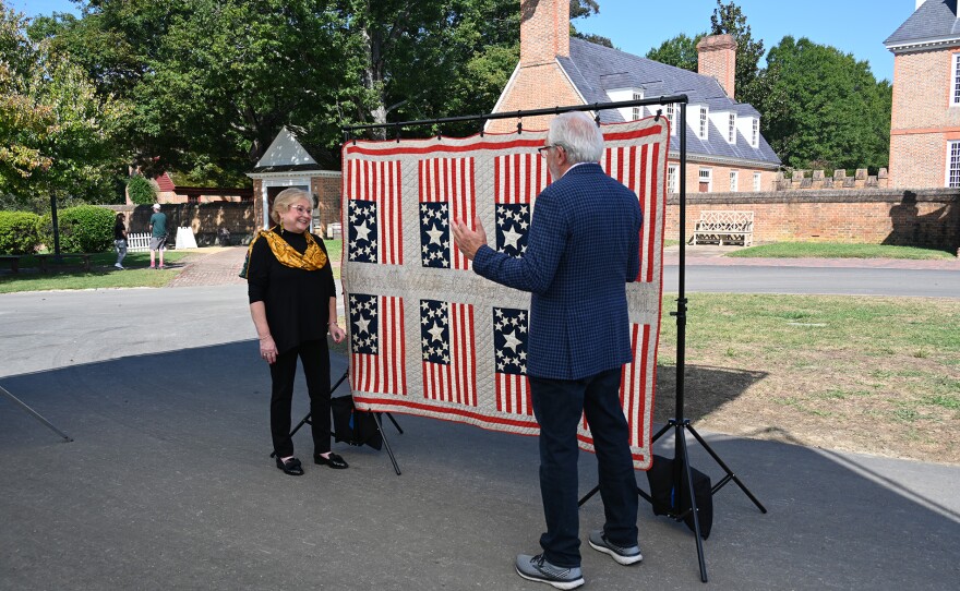 Wes Cowan (right) appraises a flag quilt, ca. 1880 in Williamsburg, Va. ANTIQUES ROADSHOW “250 Years of Americana” premieres Monday, April 20 at 8/7C PM on PBS.
