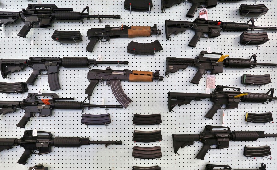 Guns are displayed at Dragonman's, an arms seller east of Colorado Springs, Colo.