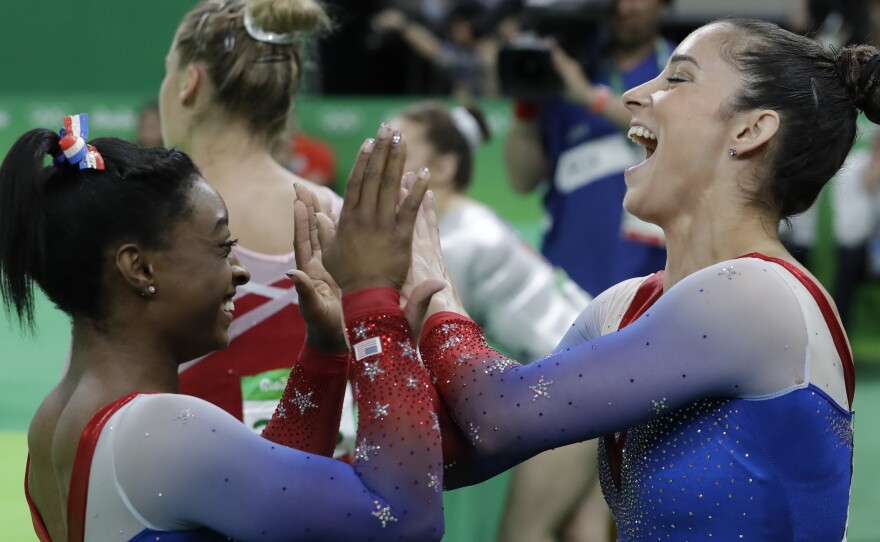 U.S. teammates, Simone Biles, who won the gold, and Aly Raisman, who won the silver, celebrate after final results for floor routine on Tuesday in Rio. It ws the fourth gold medal for Biles.