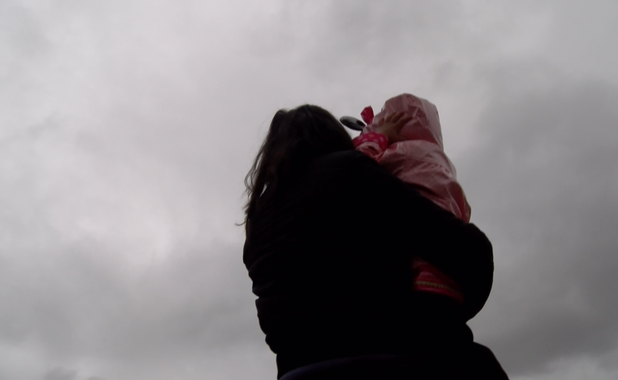 A San Diego immigrant, Marina, shows a little girl the sky, Jan. 22, 2016. 