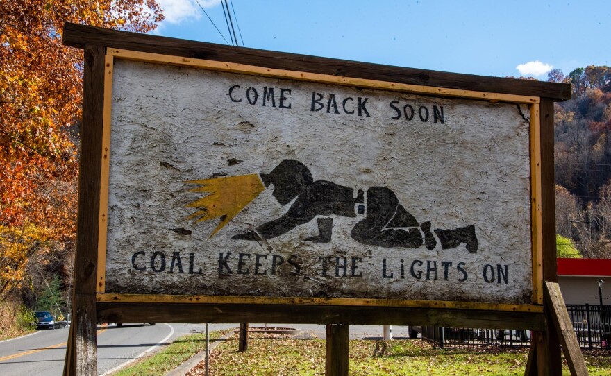 A makeshift billboard depicting a miner working in a "low coal" mine shaft greets drivers leaving Fleming-Neon, Ky.