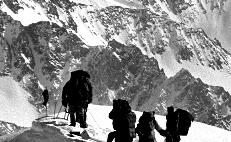 Robert F. Kennedy, left, stands atop Mt. Kennedy after placing a black flag in memorial to his late brother, President John F. Kennedy, next to, from left, Jim Whittaker, William Allard, and George Senner, March 24, 1965, in Yukon, Canada.
