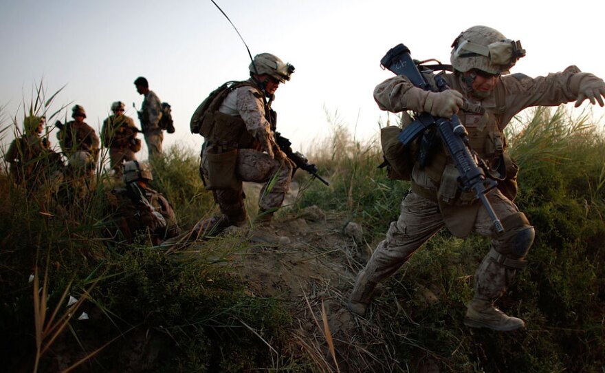Lance Cpl. Chris Garcia and other members of Golf Company cross an irrigation ditch as the 2nd Battalion, 8th Marine Regiment moves into Helmand province in July during a major offensive against the Taliban stronghold in southern Afghanistan.