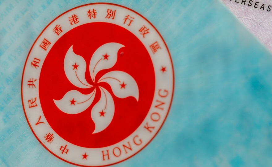 The Hong Kong Special Administrative Region (HKSAR) emblem on a page of the HKSAR passport arranged in Hong Kong, China, earlier this year. The Biden administration says it will allow Hong Kong residents to remain and work in the U.S. for at least 18 months without fear of deportation.