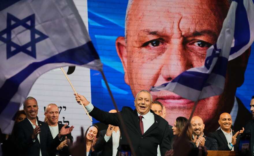 Gadi Eisenkot, leader of the Yashar ("Straight") party, waves an Israeli flag onstage following the release of the first exit poll results in Israel's general election in Tel Aviv, Israel, Wednesday, Oct. 28, 2026.