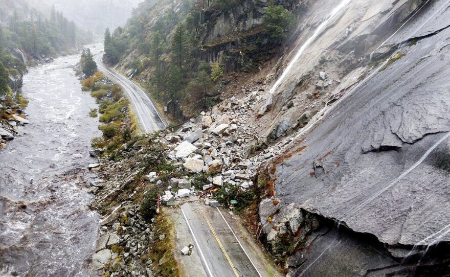FILE - Rocks and vegetation cover Highway 70 following a landslide in the Dixie Fire zone on Oct. 24, 2021, in Plumas County, Calif.