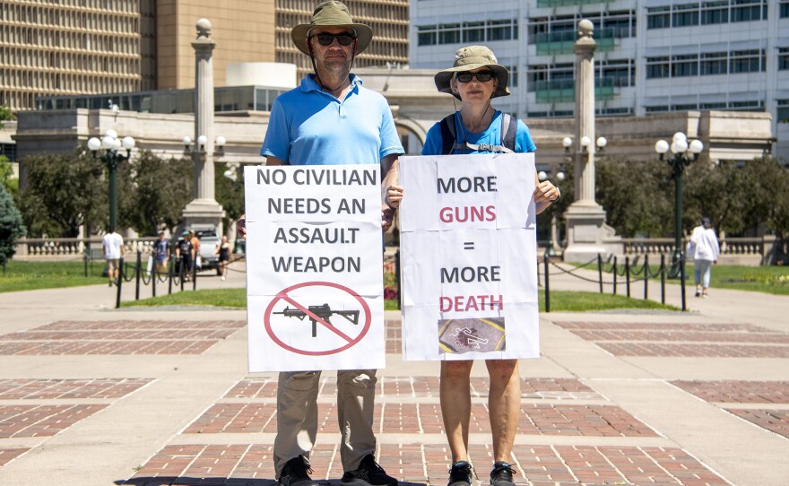 Denver: Tim (left) and Debbie Burke brought signs to a "March For Our Lives" rally at Civic Center Park.