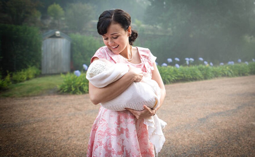 Arianwen Parkes-Lockwood as Olivia Bligh holding the baby.