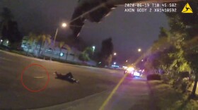 A still from a police-worn camera video showing a crowbar lying in the roadway near Rosendo Sandoval Quezada after he had been shot on June 19, 2020.