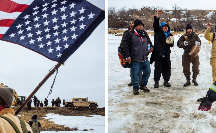 Protestors stand on the Cannonball River as police secure the northern bank after they cleared the Oceti Sakowin camp.