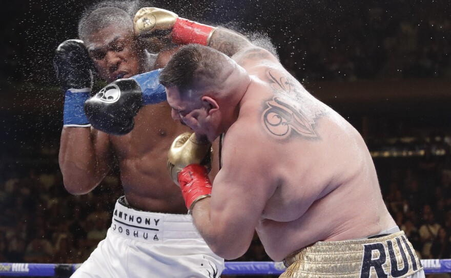 Andy Ruiz Jr. (right) and Anthony Joshua exchange punches during the heavyweight championship match Saturday. Ruiz won in the seventh round.